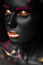 Black skin : fashion portrait of a dark-skinned girl with color make-up.Beauty face. Picture taken in the studio on a black background.