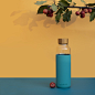blue and white bottle with red rose on blue surface