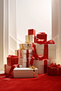 In this illustration, red boxes with ribbon on top of them, in the style of large-scale photography, elegant compositions, carpetpunk, xmaspunk, minimalist still lifes, light white and gold, lively interiors