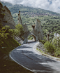 man walking on road near arch