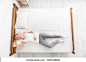 Top view of woman lying in bed with closed eyes, daytime sleep, copy space
