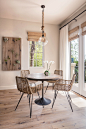 Dining room - mediterranean medium tone wood floor and brown floor dining room idea in Santa Barbara with beige walls