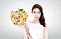 a woman holding an apple shape figure创意图片素材 - TongRo Images