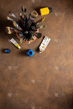 在陶罐和美术画家工具上使用画笔绘制桌面背景纹理。用于绘画的画笔作为艺术颜料，画静物