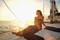 Asian woman sitting on yacht deck by Gable Denims on 500px