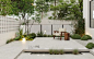 This may contain: an outdoor garden with white walls and trees