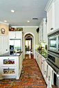 Rustic brick floor. And I'm obsessed with the end glass cabinets for potatoes!!!