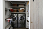 Behind sliding barn doors is this hard-working laundry closet in Napa Valley, complete with two wall-mounted collapsible drying racks. Photograph by Mimi Giboin for Remodelista, from Small Space, High Style: A Napa Valley Laundry Room.