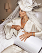 Looking bridal chic in white, Emily DiDonato poses in Anya Caliendo feather hat and Mae’s Sunday jumpsuit