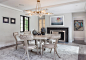 Enclosed dining room - large transitional brown floor and light wood floor enclosed dining room idea in Boston with a standard fireplace, a metal fireplace and gray walls