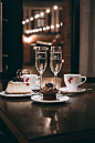 two champagne flute glass beside sliced cake and cupcake