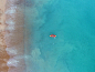 A drone view of a person kayaking in the sea in Brighton