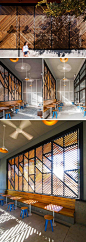 This modern coffee shop design has a houndstooth patterned cedar screen to create visual interest from the street and from within the enclosed patio. Inside the patio, sunlight is filtered through the pattern allowing for interesting shadows. The screen a