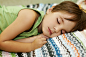 Boy sleeping on colorful striped blanket