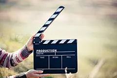 Hands holding a movie clapboard