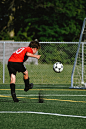 a boy kicking a football ball