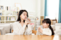 Mother And Daughter Drinking Water At Home