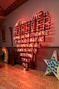 This may contain: a neon sign that says love is forever on the wall next to a wooden floor