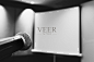 microphone ready to use in the podium and the projector screen on the back of the meeting room for the press conference. selective focus. black and white photo.