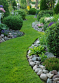 The lawn is the garden path with nicely edged beds bordered in rocks...: 