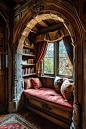 This may contain: a window seat in the corner of a room with bookshelves on either side