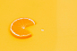 sliced orange fruit on yellow surface