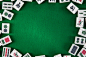 White-green tiles for mahjong on on green cloth background
