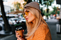close-up-portrait-dreamy-fair-haired-woman-waiting-friend-outdoor-drinking-latte