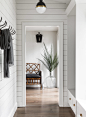 Country dark wood floor mudroom photo in Seattle with white walls