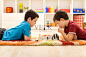 Kids playing chess on colorful rug