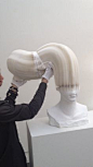 Li Hongbo demonstrating how his paper sculptures work.