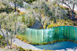 apple park's mirage sculpture takes shape as iridescent glass pillars winding through trees