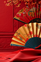 Golden fans and fans, red backdrop, and other decorations, in the style of vivid color blocks, fan ho, 3d, wrapped, neo-traditionalist, imitated material, trompe-l'oeil folds