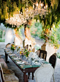 elegant and yet also a bit shabby chic outdoor wedding decor, love the chandeliers: 