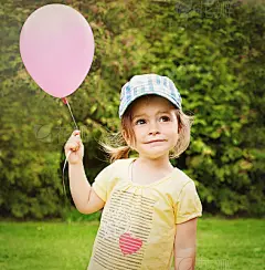 Girl with a pink balloon looking up