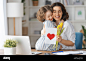 happy-mothers-day-child-daughter-congratulating-mom-and-giving-her-flowers-and-card-mum-and-girl-smiling-and-hugging-family-holiday-and-togetherne-2J2WF6A 拷贝