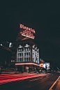 A building in Columbus with a red light trail passing nearby on an urban street