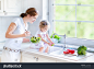 stock-photo-young-happy-mother-and-her-cute-curly-toddler-daughter-washing-vegetables-together-in-a-kitchen-177144761