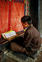 This is a re-upload of an old photo I showed here several years ago. I have rescanned it and - hopefully - improved the colours and sharpness.

Here is the original note:
A young novice studying the scriptures. This picture was taken 1986 in Sera near Lha