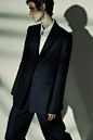 Model in dark navy suit with white button down