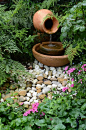 Shade garden with innovative water feature as focal point.