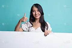 年轻的亚洲女性竖起大拇指，示意空白。