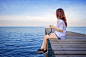 girl-sitting-alone-wooden-bridge-sea-vintage-tone-style
