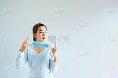 亚洲妇女脱下防护口罩回归正常生活，冠状病毒的终结理念。