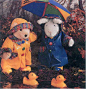 two stuffed animals standing next to each other in the water with umbrellas over their heads