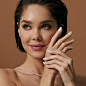 Model smiling while wearing KISS Bare But-Better Short TruNude nail shades