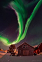 The northern lights or aurora borealis dances in the night sky over a village in northern Norway. Between the two aurora curtain stars of the Big Dipper appear. To their left is the North Star, Polaris, and the rest of Little Dipper. Babak Tafreshi, Dream