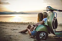 Couple on the beach with retro bike