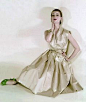 1951 Model in silk shantung dress by Nettie Rosenstein worn with silk shantung pumps adorned with white snowflakes