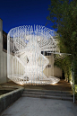 Whimsical Cage Redefines Public Space.  La Cage aux Folles (The Cage of Follies). Users enter through a gently contoured opening in the cylinder-shaped cage, which guides them into a modest open air labyrinth of white steel. The space offers an intimate s